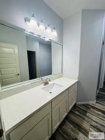 a bathroom with a double vanity sink and a mirror