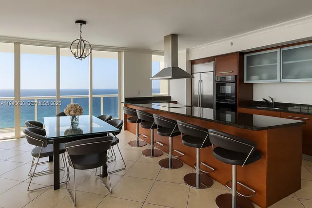 a kitchen with a dining table and chairs