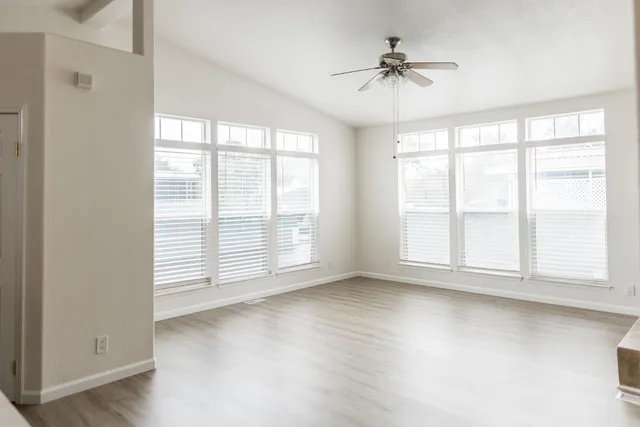 a kitchen with stainless steel appliances granite countertop a sink counter space cabinets and a large window