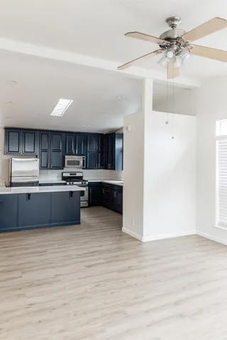 a kitchen with a sink stove and cabinets