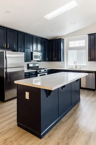 a close view of a stove a microwave and cabinets