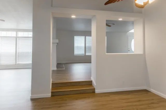 a white toilet sitting next to a white wall