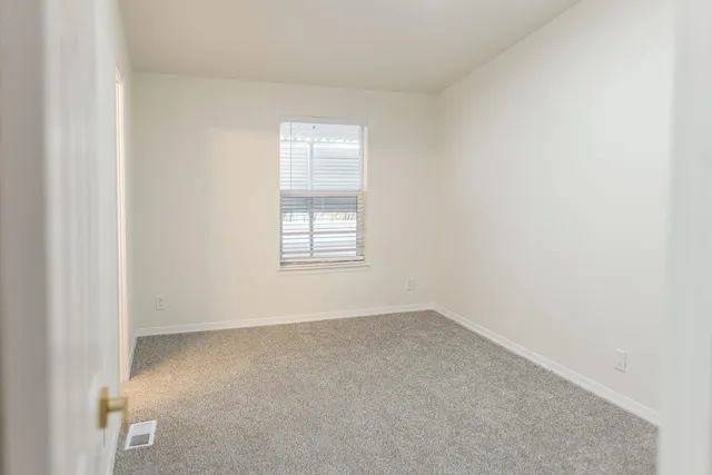 a view of an empty room with closet