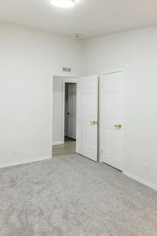 a view of hallway with wooden floor