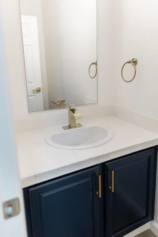 a spacious bathroom with a double vanity sink and mirror