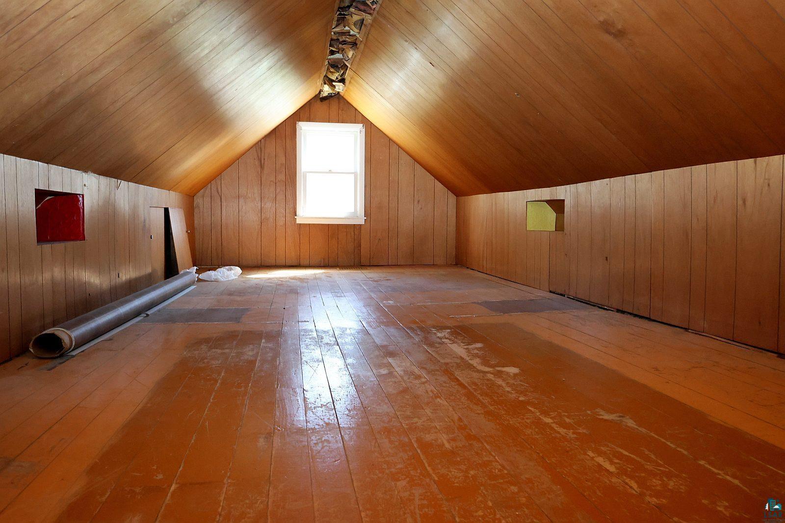 83185 Washington Avenue Port Wing, WI 54865 - Photo 18 of 26 Expansive attic space featuring pitched wood paneling, wood-finish flooring, and a central window