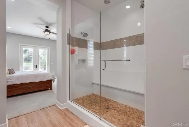 a bathroom with a double vanity sink toilet and a mirror