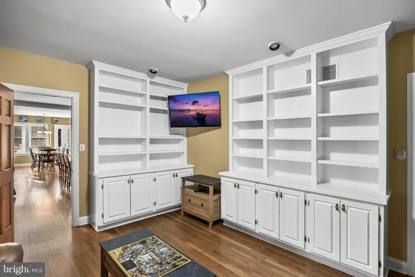a living room with furniture a fireplace and a large window