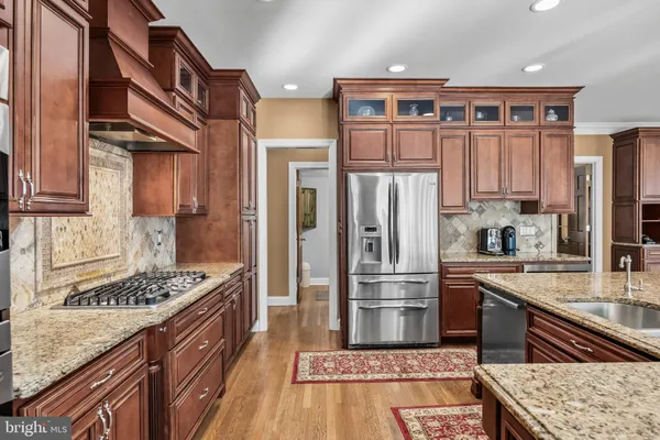 a kitchen with stainless steel appliances granite countertop a stove and cabinets