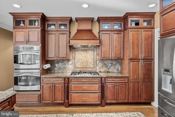 a kitchen with a sink stove and wooden cabinets