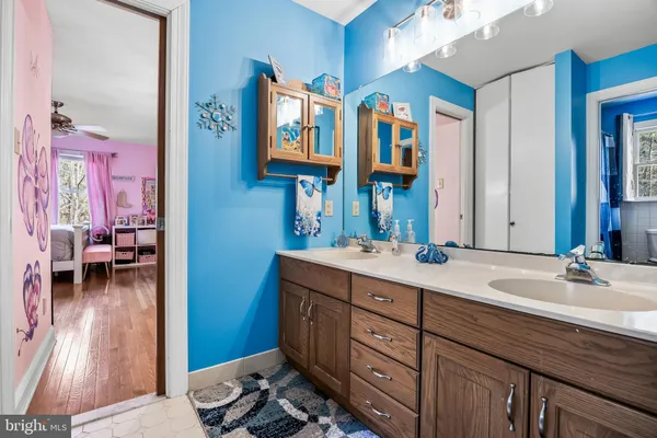 a view of a workspace with furniture and a ceiling fan