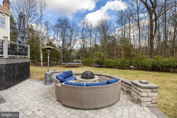 a view of a roof deck with couches and wooden floor