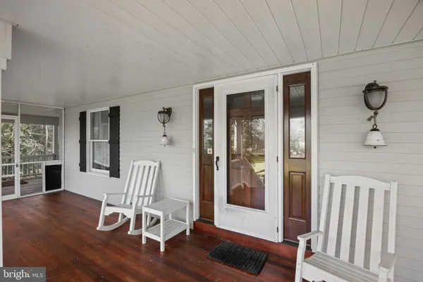 a view of a livingroom with furniture wooden floor and windows