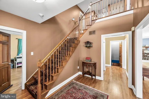 a view of entryway and hall with wooden floor