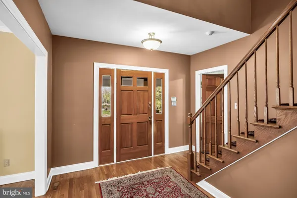 a view of entryway with wooden floor and stairs