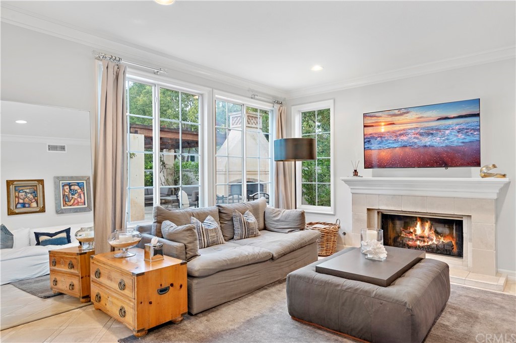 1 Meryton Irvine, CA 92603 - Photo 18 of 42 a living room with furniture large window and a fireplace