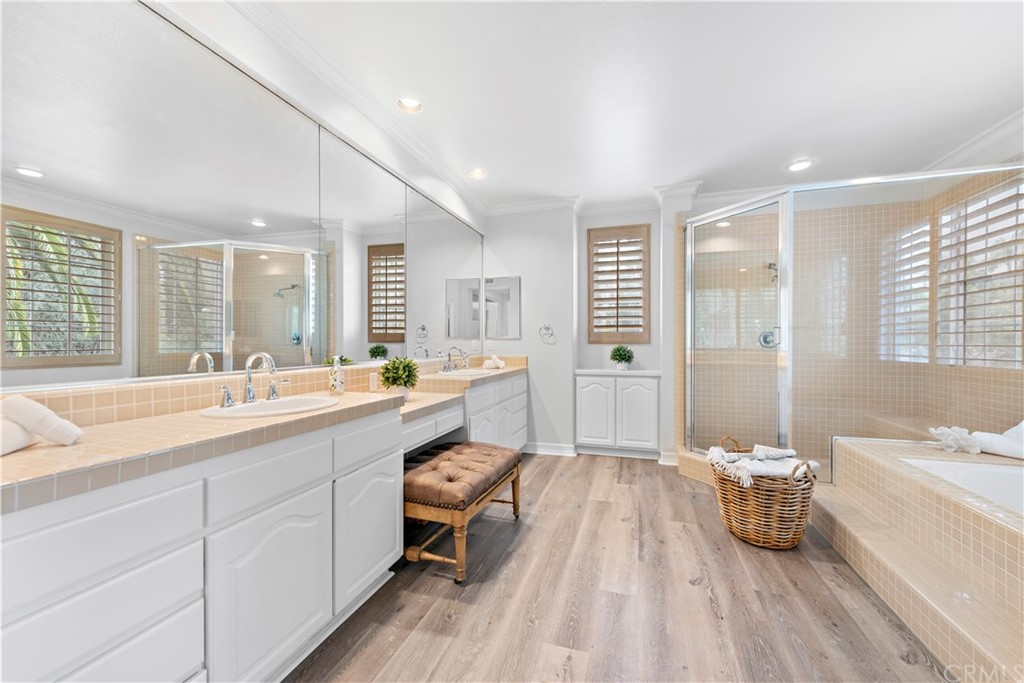 1 Meryton Irvine, CA 92603 - Photo 24 of 42 a spacious bathroom with a double vanity sink a mirror and a bathtub