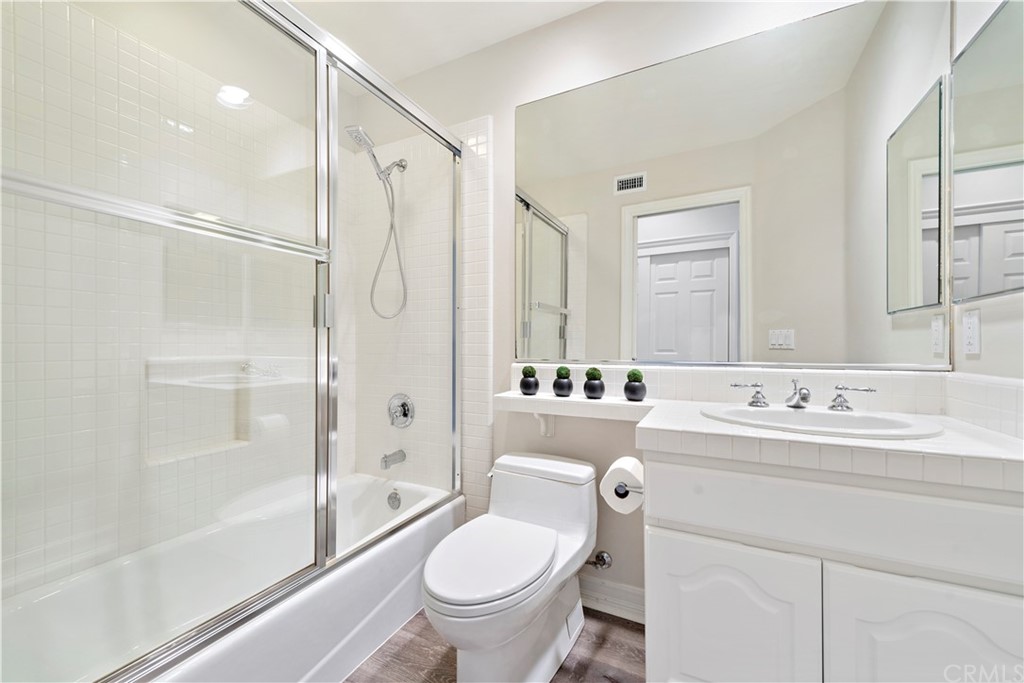 1 Meryton Irvine, CA 92603 - Photo 28 of 42 a bathroom with a double vanity sink toilet mirror and shower