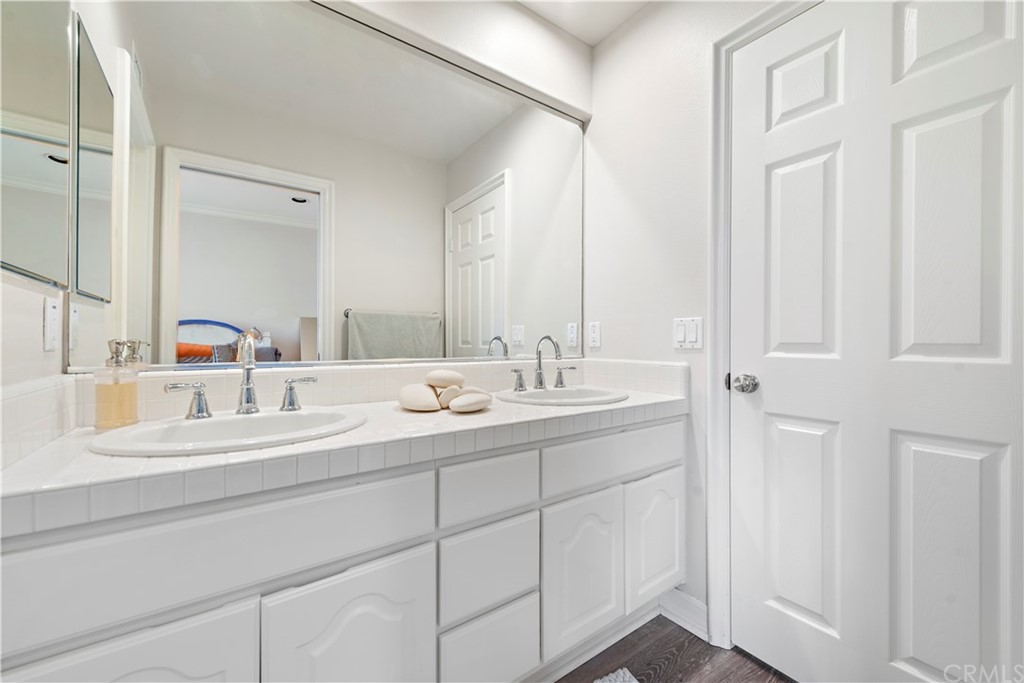 1 Meryton Irvine, CA 92603 - Photo 31 of 42 a bathroom with a double vanity sink and a mirror