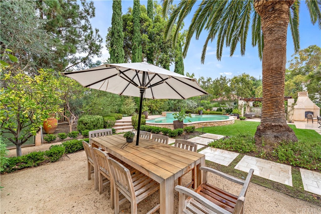 1 Meryton Irvine, CA 92603 - Photo 33 of 42 a backyard of a house with table and chairs under an umbrella