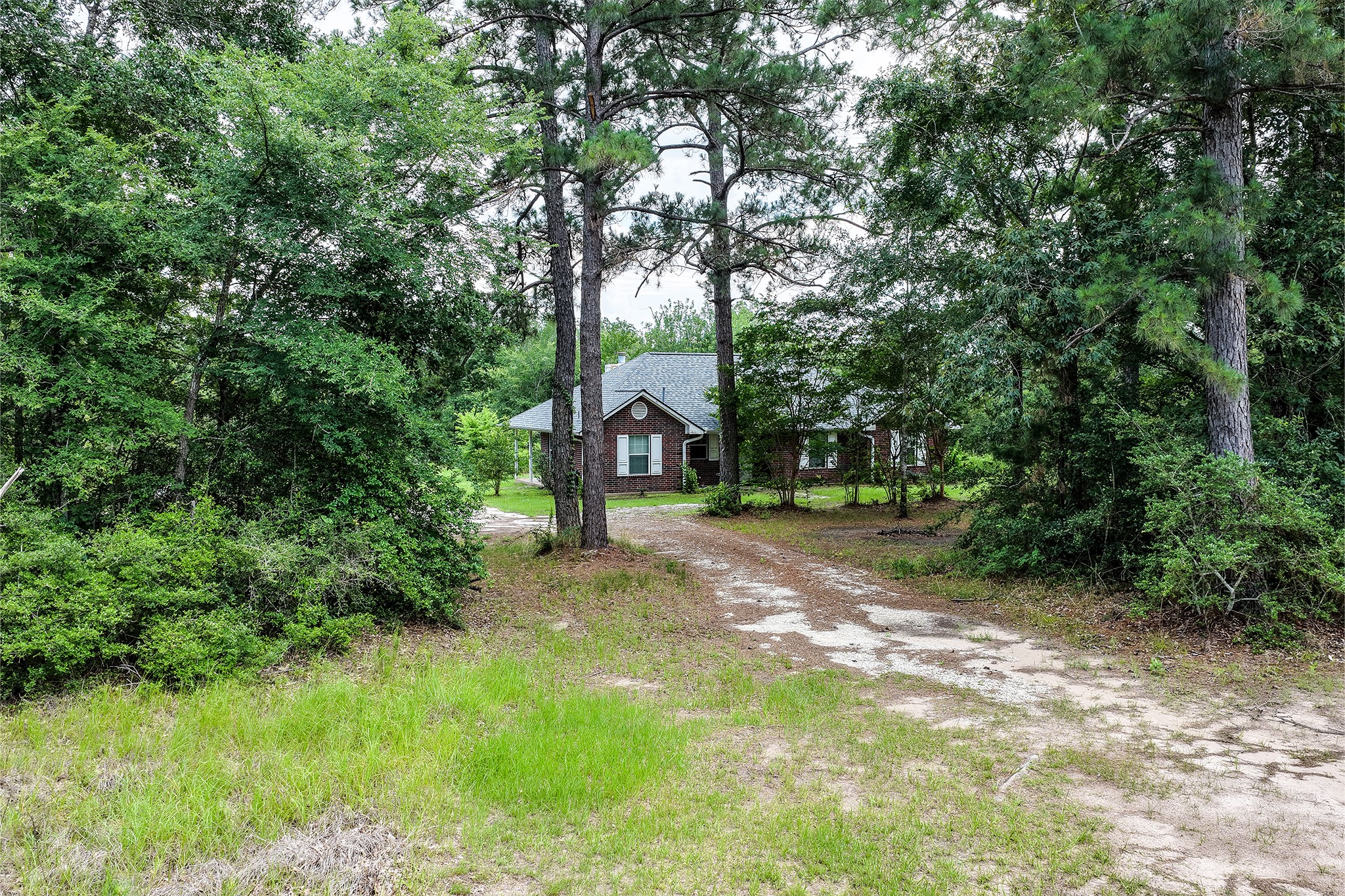691 Bishop Road Huntsville, TX 77320 - Photo 2 of 32 a view of a house with a yard