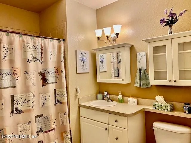 a bathroom with a sink mirror and vanity