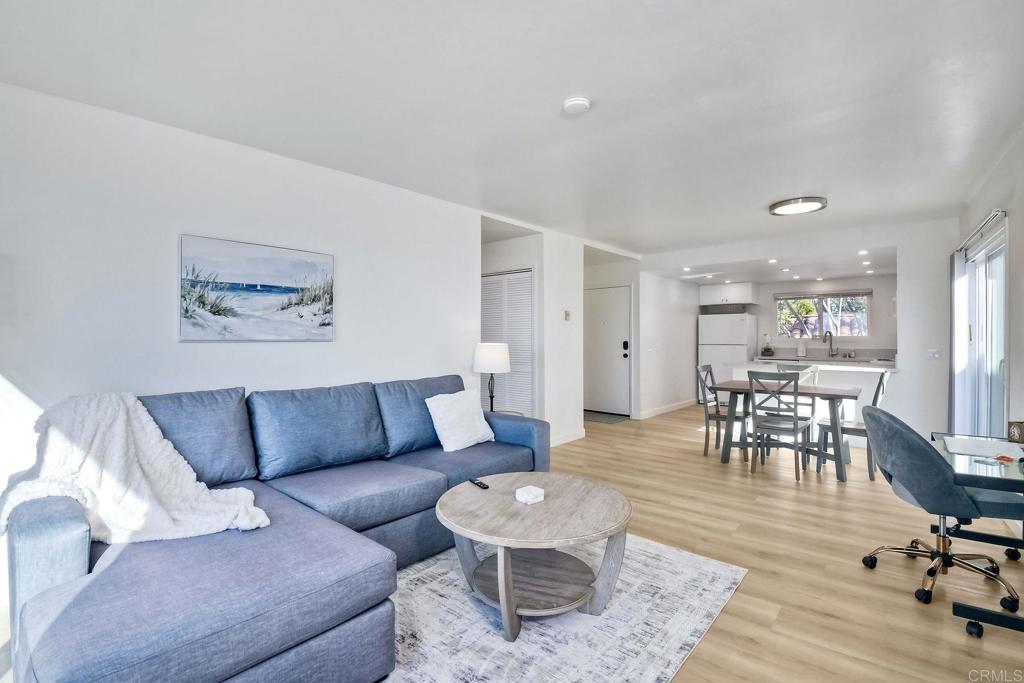 6675 Paseo Del Norte, Unit B Carlsbad, CA 92011 - Photo 1 of 19 a living room with furniture and wooden floor