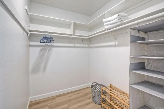 a view of walk in closet with empty racks