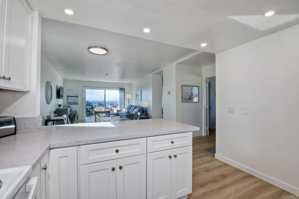 6675 Paseo Del Norte, Unit B Carlsbad, CA 92011 - Photo 7 of 19 a view of a kitchen counter space cabinets and wooden floor