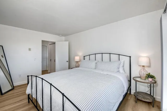 a bedroom with a bed and a lamp on table