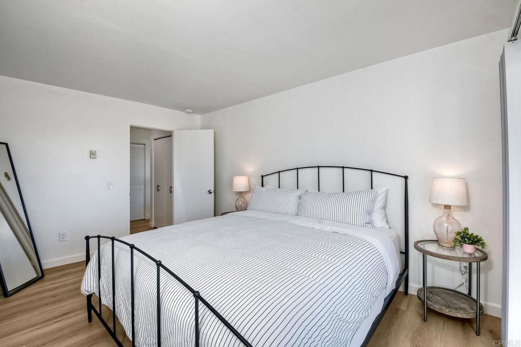 6675 Paseo Del Norte, Unit B Carlsbad, CA 92011 - Photo 10 of 19 a bedroom with a bed and a lamp on table