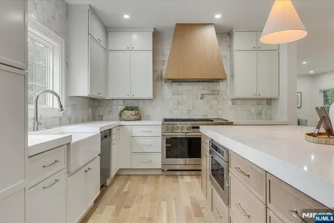 a kitchen with cabinets appliances and a sink
