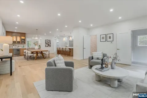 a living room with furniture and view of kitchen