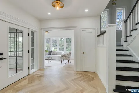 a view of an entryway with wooden floor and door