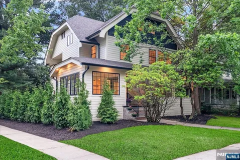 a front view of house with a garden