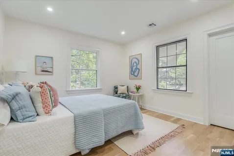 a spacious bedroom with a bed and a table in it