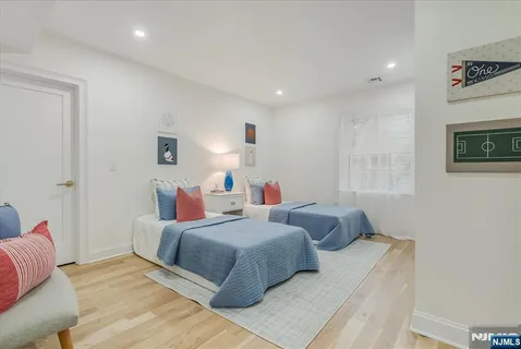 a spacious bedroom with a bed a couch and potted plant on the table
