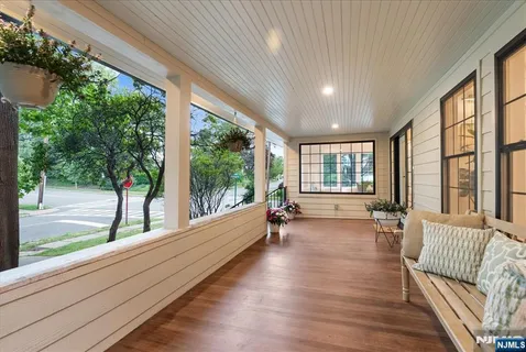 a view of a large room with wooden floor and windows