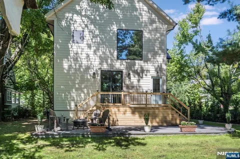 a view of a house with a yard and tree s