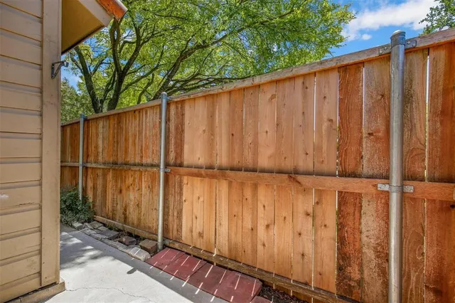 a view of a backyard with wooden fence