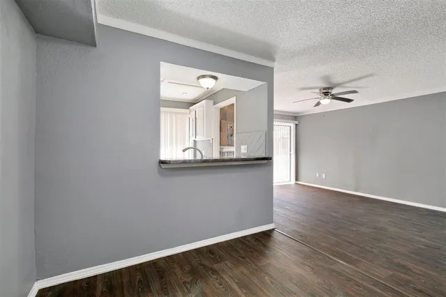 a view of a hallway with wooden floor and a chandelier