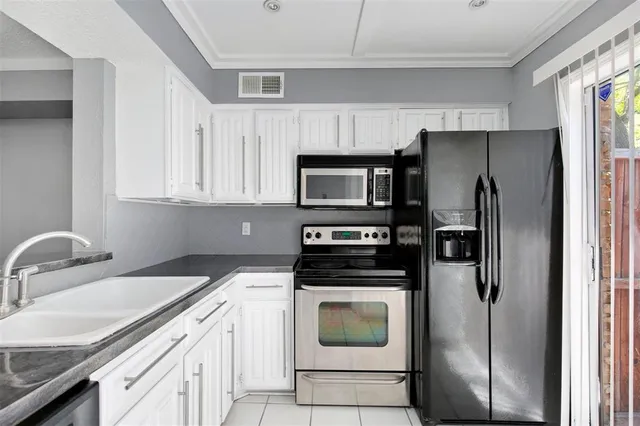 a kitchen with a refrigerator sink and microwave