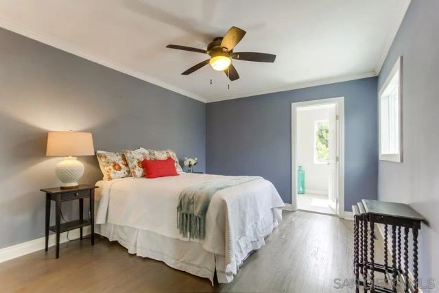 a bathroom with a granite countertop sink a large mirror and a window