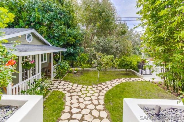 a living room with stainless steel appliances granite countertop furniture and a wooden floor