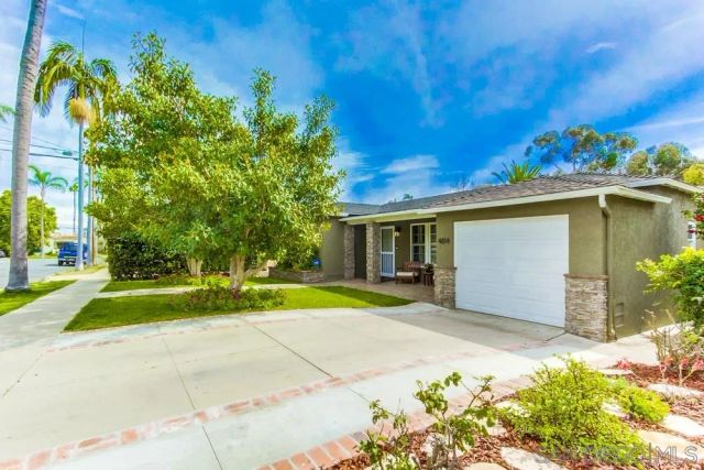 a view of a house with a yard and tree s