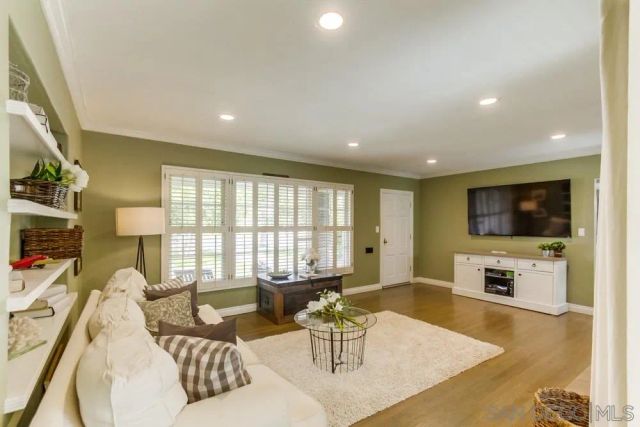 a living room with furniture fireplace and flat screen tv