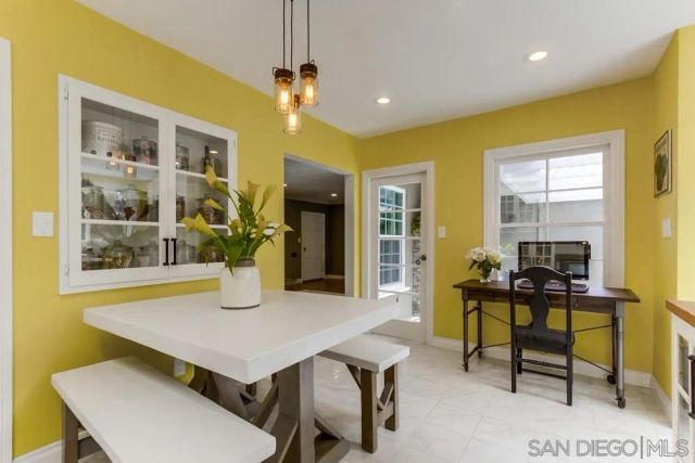 a view of a dining room with furniture and a potted plant