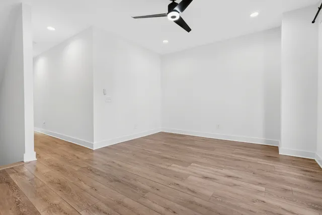 a view of a room with wooden floor