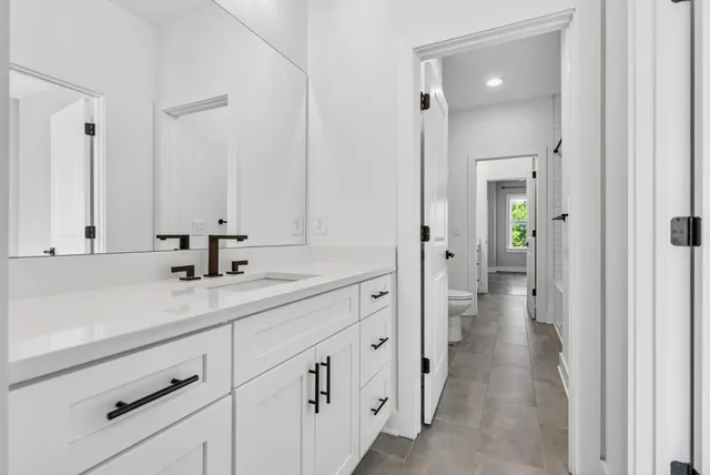 a en suite bathroom with a sink and mirror