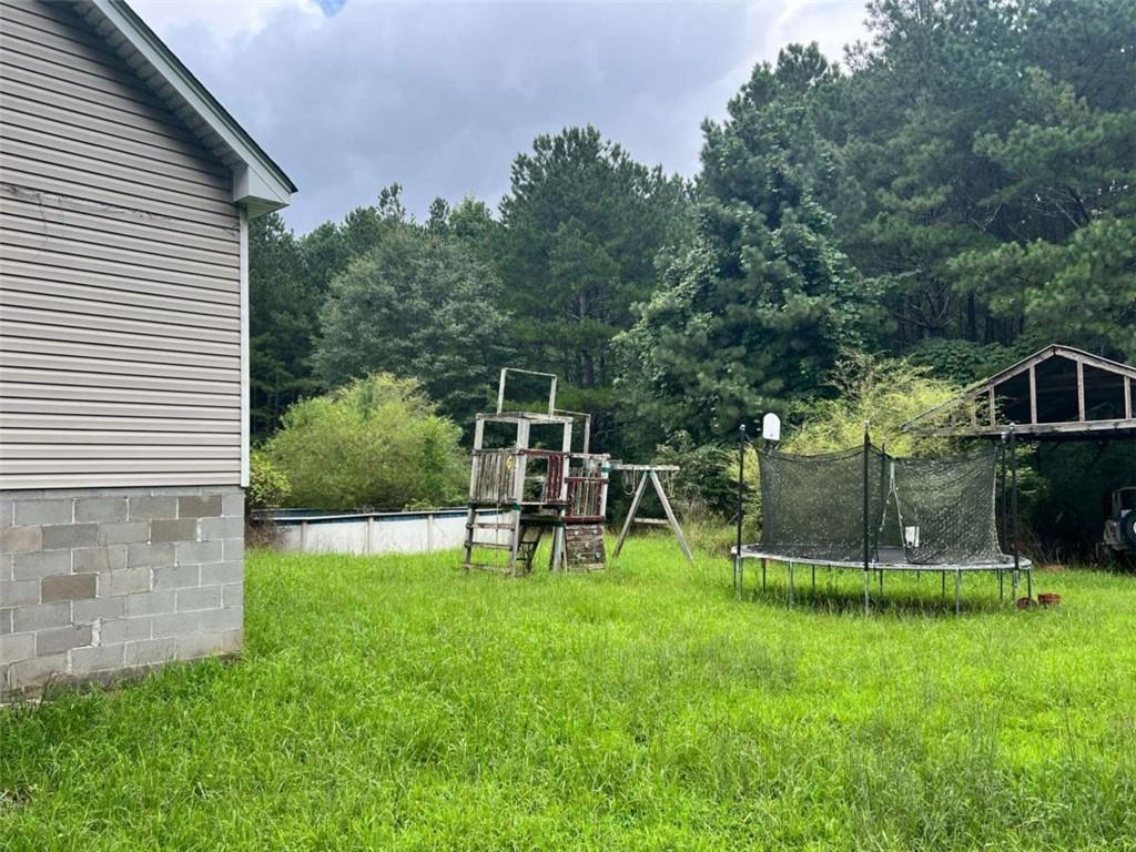 1383 Sims Road Southeast Statham, GA 30666 - Photo 3 of 9 a view of a chair and table and garden